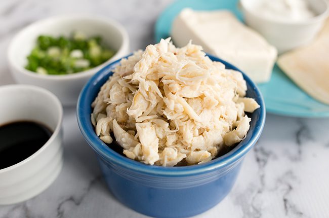 white crab meat in a blue bowl