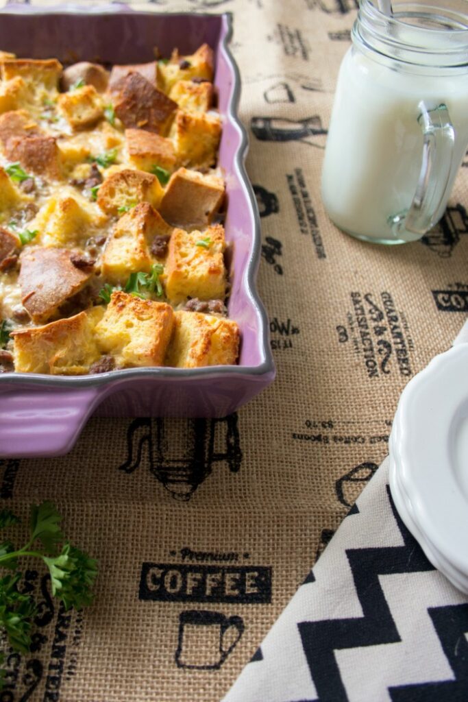 A purple baking dish filled with make ahead breakfast casserole