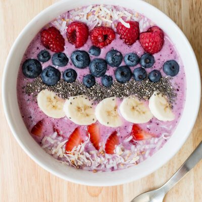 Overhead picture of a large white bowl filled with smoothie and fresh fruit