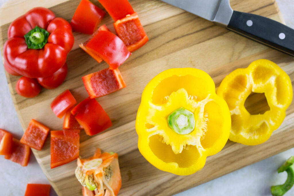 overhead shot of bell peppers chopped on cutting board