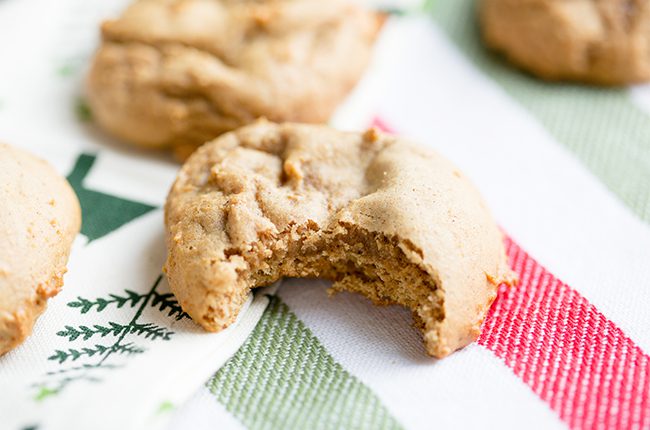 Soft gingerbread cookie with a bite taken out of it on a red white and green napkin