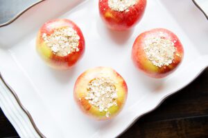 Overhead picture of baked apples going into oven