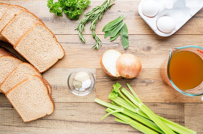 Ingredients for sage and onion stuffing recipe on a cutting board