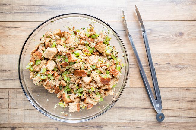 Large glass bowl filled with stuffing ingredients