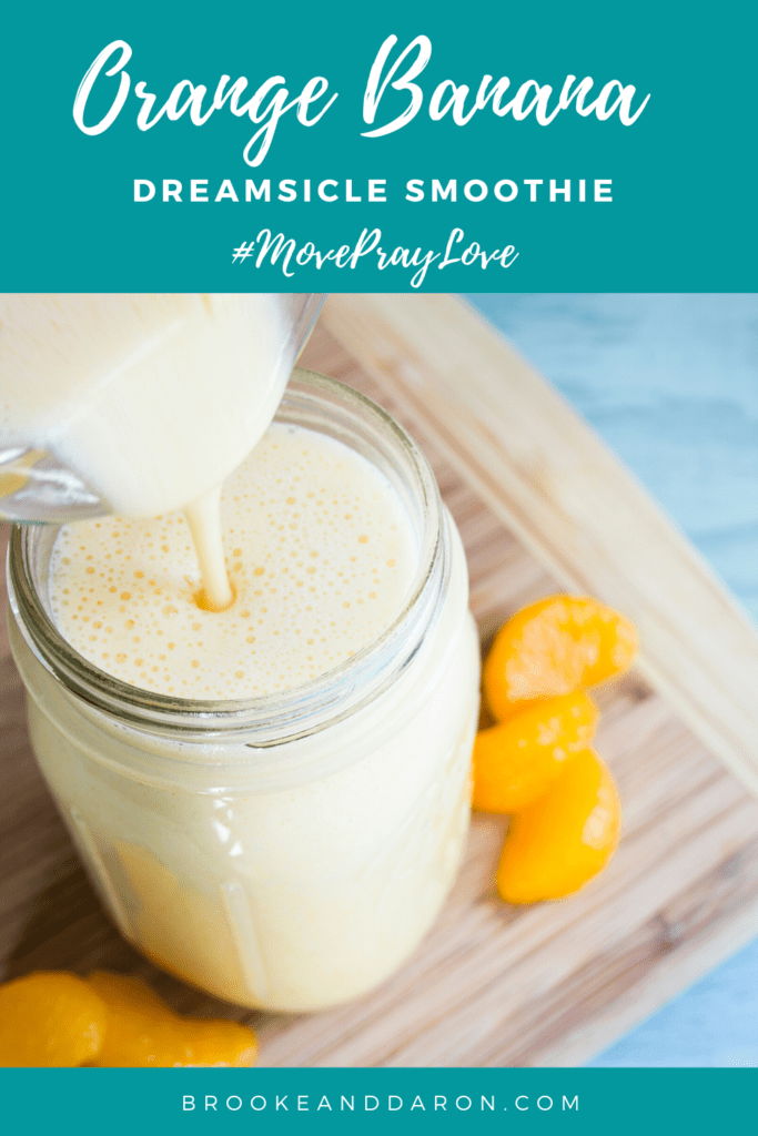 Orange banana smoothie being poured into jar