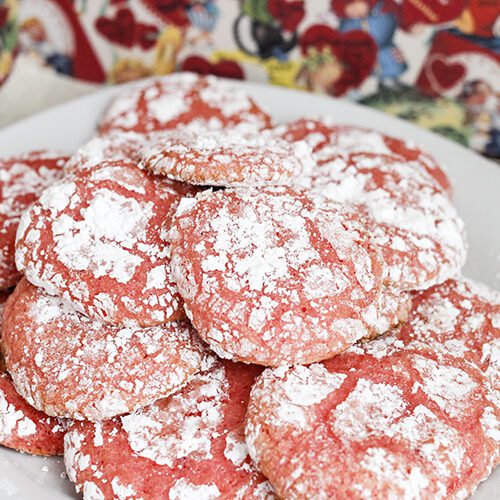 A white plate with several baked strawberry cake mix cookies