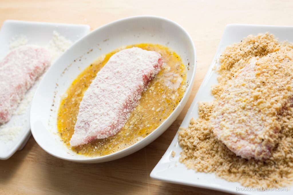 Parmesan pork chops being battered
