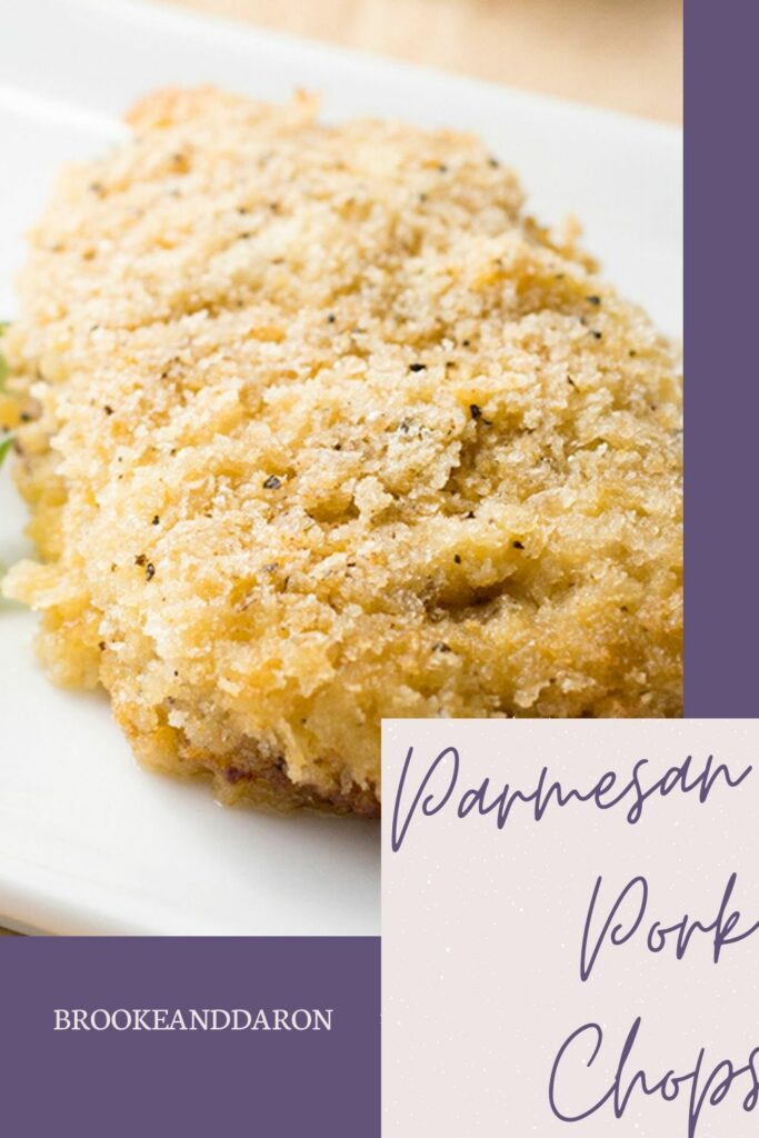 Parmesan pork chop on white plate with parsley