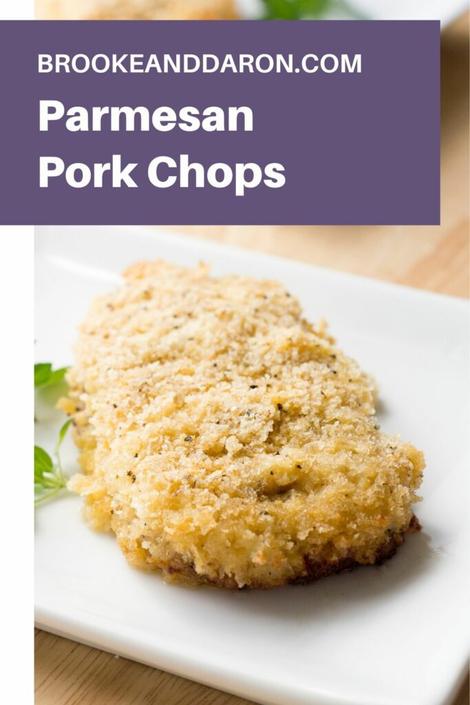 Parmesan pork chop on white plate with parsley