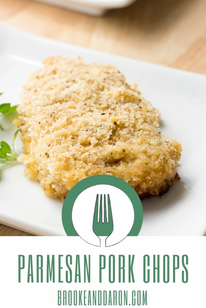 Parmesan pork chop on white plate with parsley