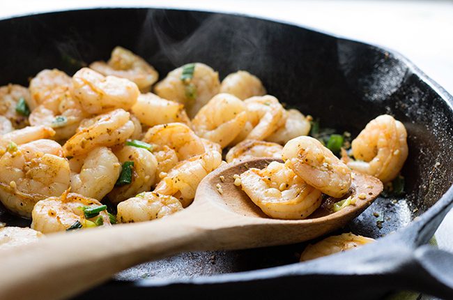 how to make shrimp and grits close up of shrimp in skillet