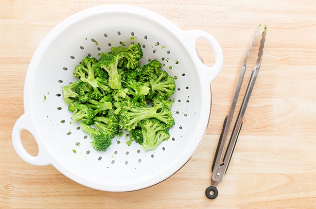 overhead shot of broccoli in strainer for baked broccoli tots recipe
