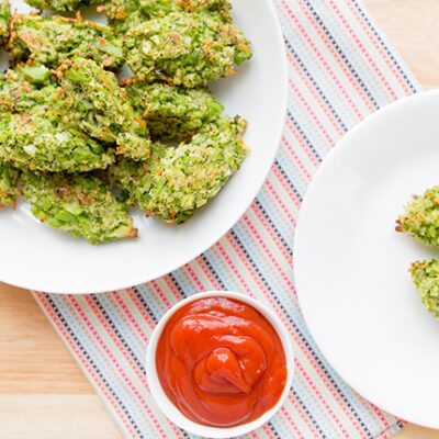 overhead shot of baked broccoli tots with ketchup