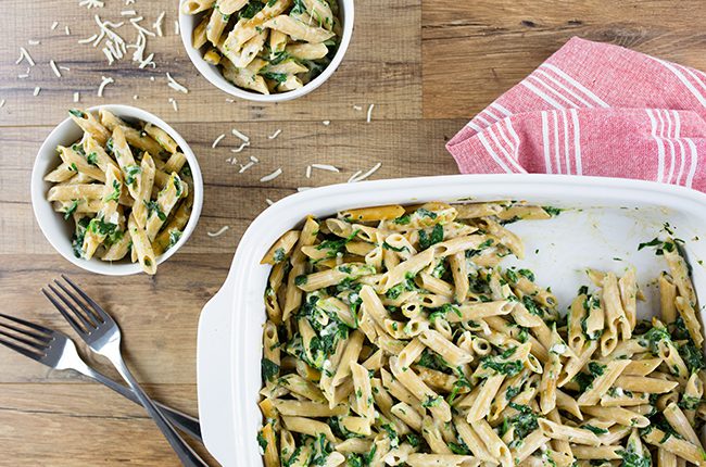 Overhead picture of a baking dish filled with spinach pasta in homemade alfredo sauce