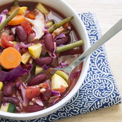 Simple Cabbage Soup in a large white bowl on a blue and white napkin