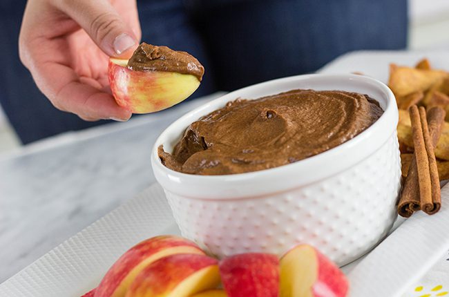 chocolate pumpkin dip with an apple dipped