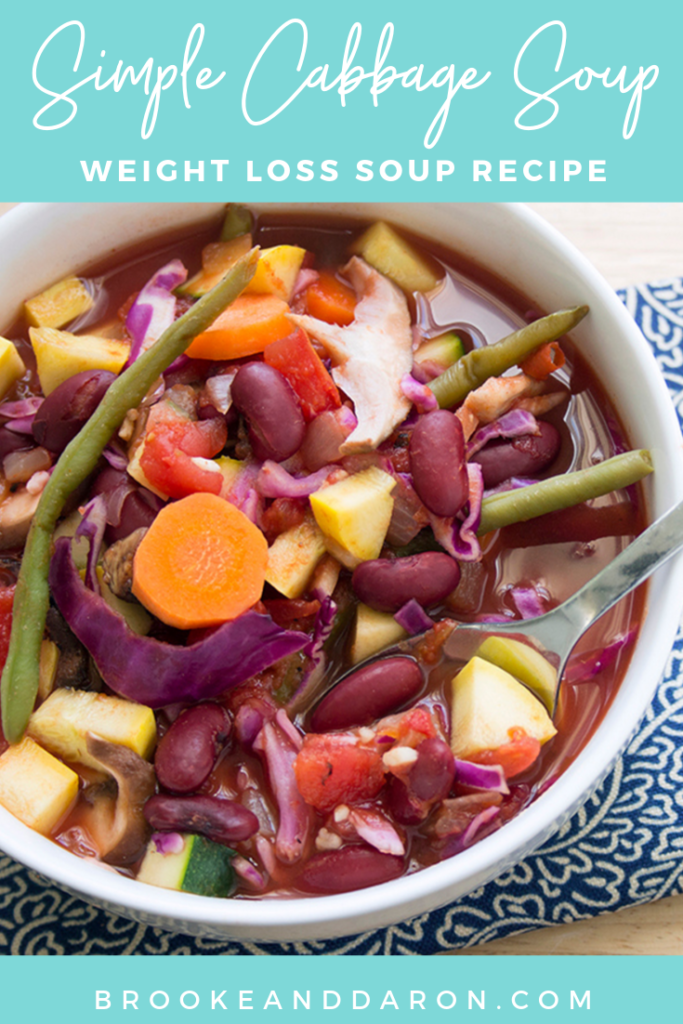 A large white bowl full of colorful cabbage soup