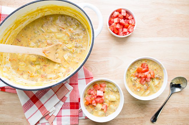 Overhead picture of a large stockpot filled with hearty cheese cheeseburger soup