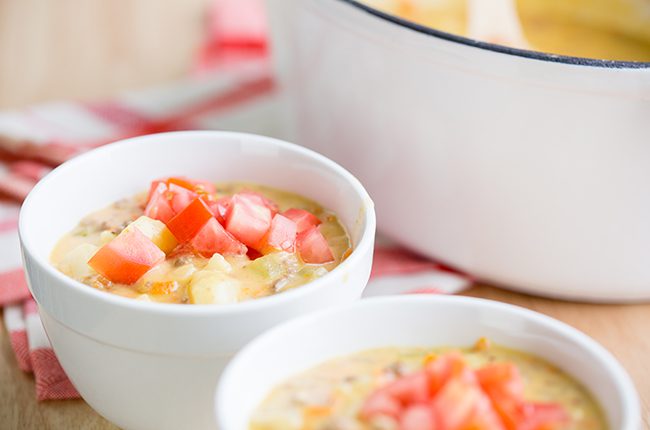 Side picture of two small white bowls filled with cheeseburger soup