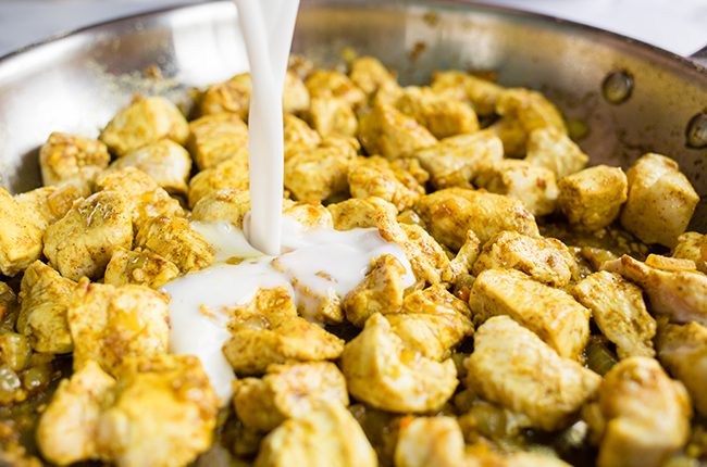 Cooking chicken with curry spices