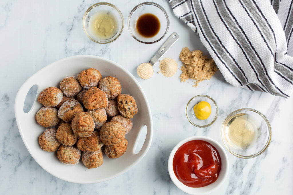 Ingredients to make bbq bourbon meatballs on white counter