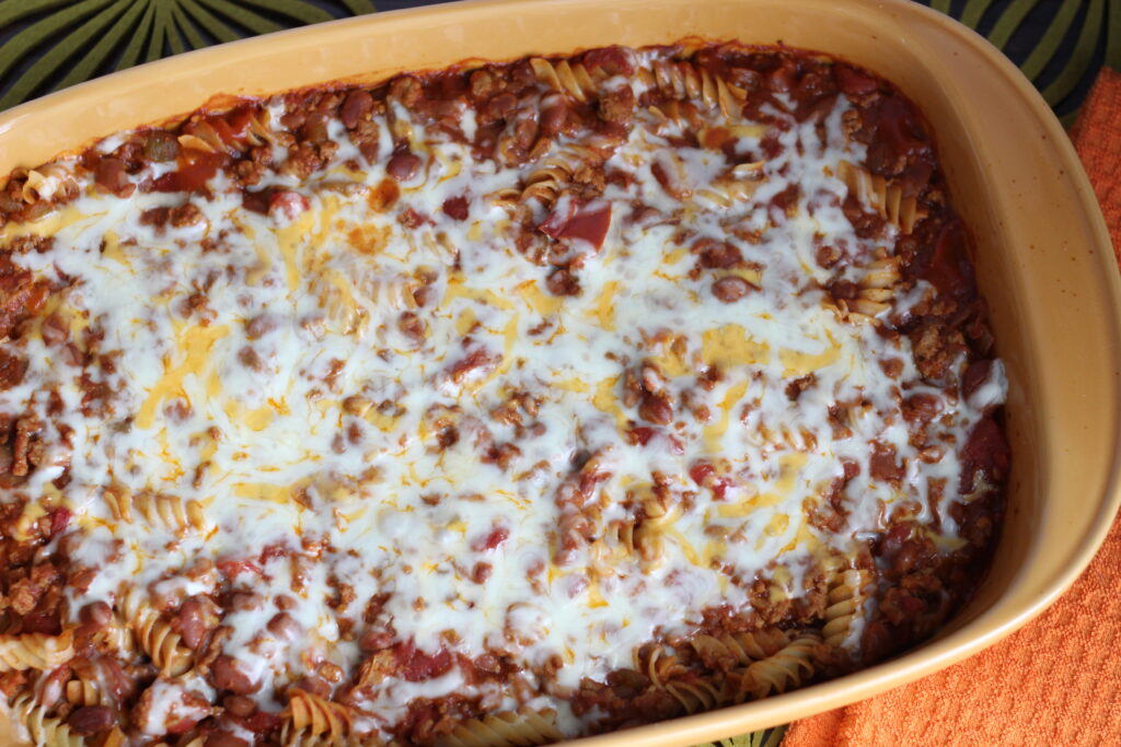 Large orange baking dish filled with chili mac recipe