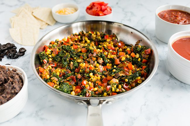 Mixing the filling for mexican lasagna in large bowl