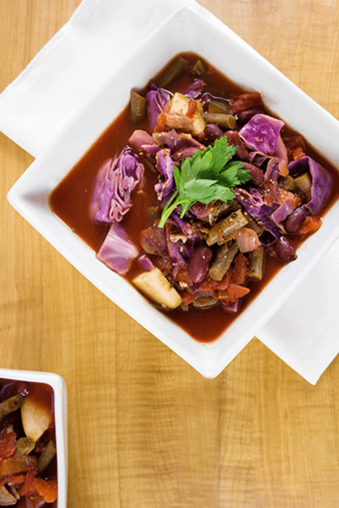 Overhead picture of a square white bowl filled with cabbage soup recipe