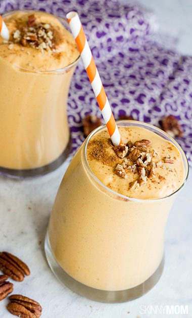 2 glasses pumpkin smoothie recipe sitting on white counter with purple cloth in background