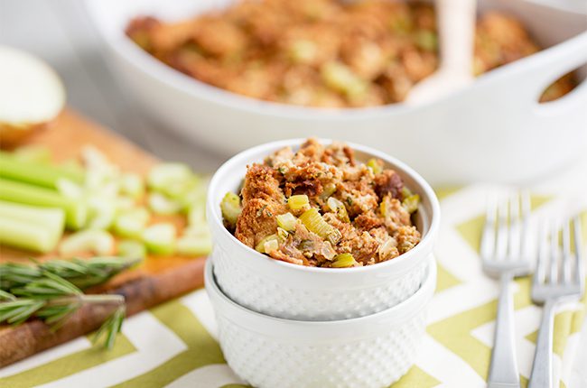 A small white bowl filled with an herbed stuffing recipe