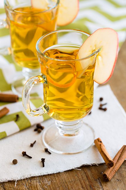 Tall glass mugs of apple cider