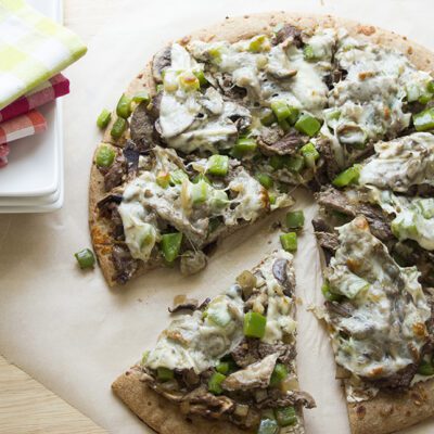 Up close overhead picture of a sliced philly cheesesteak pizza