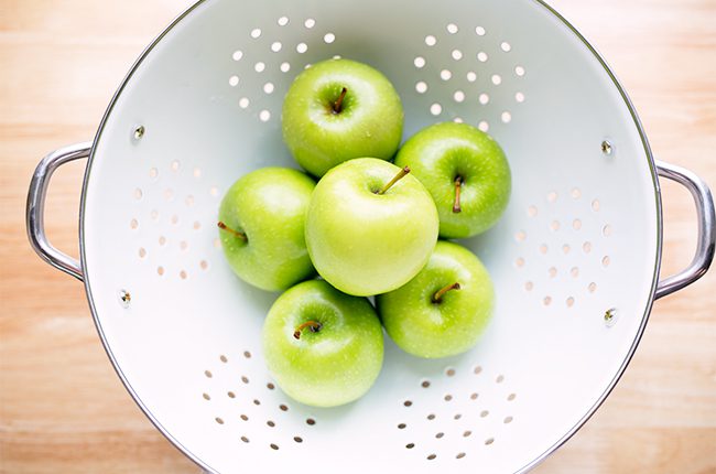 Green apples in collander