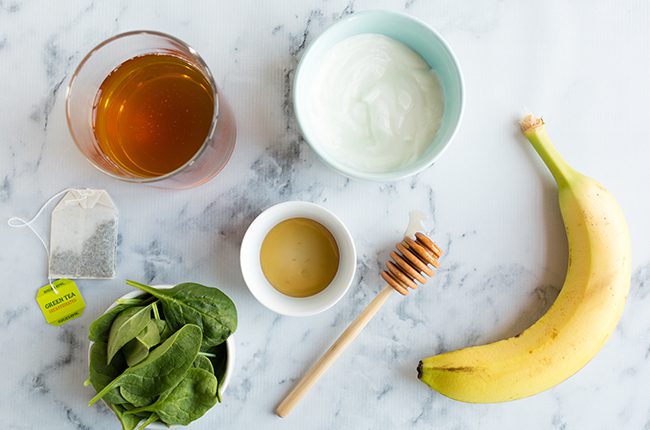Ingredients for green tea smoothie on marble counter