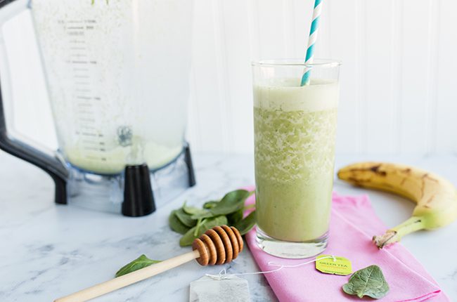 Smoothie on counter next to blender