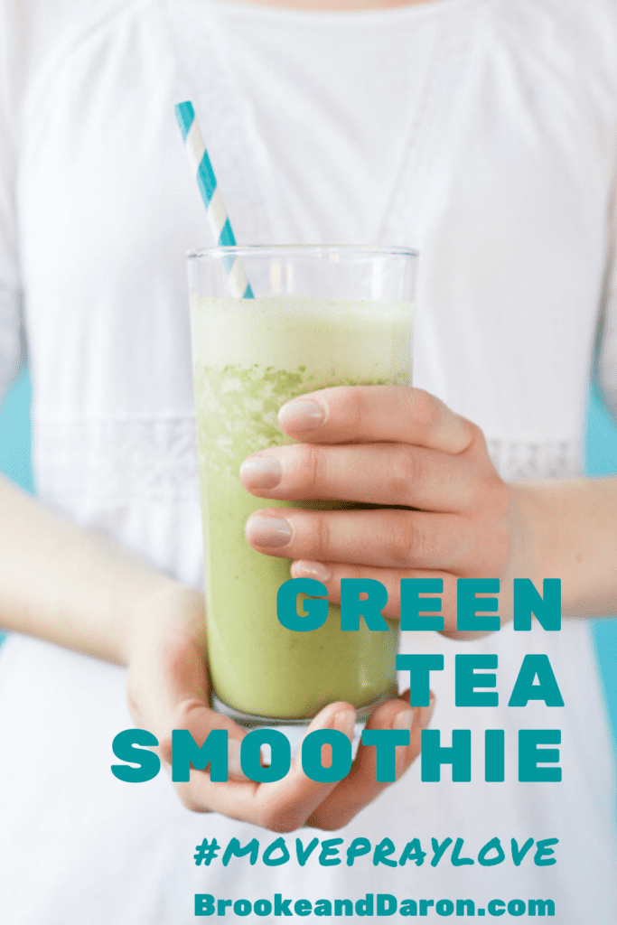 Woman holding glass of smoothie