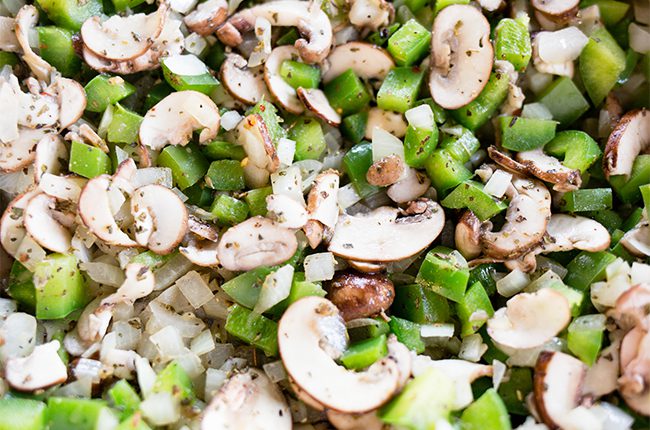 Mushrooms peppers and onions cooked