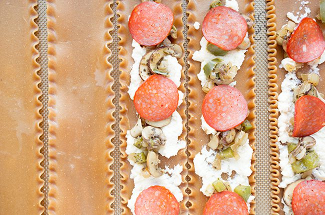 Pizza lasagna roll being assembled