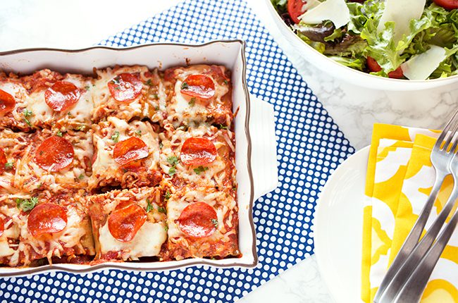 Pizza lasagna roll up in casserole dish