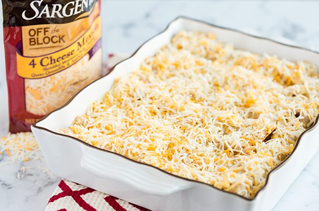 Overnight breakfast enchilada casserole covered with cheese