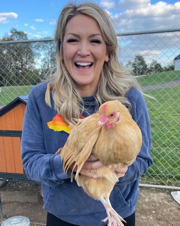 brooke on the farm with a chicken